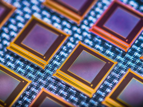 Stylized photograph of chip processors in blue, purple, and orange