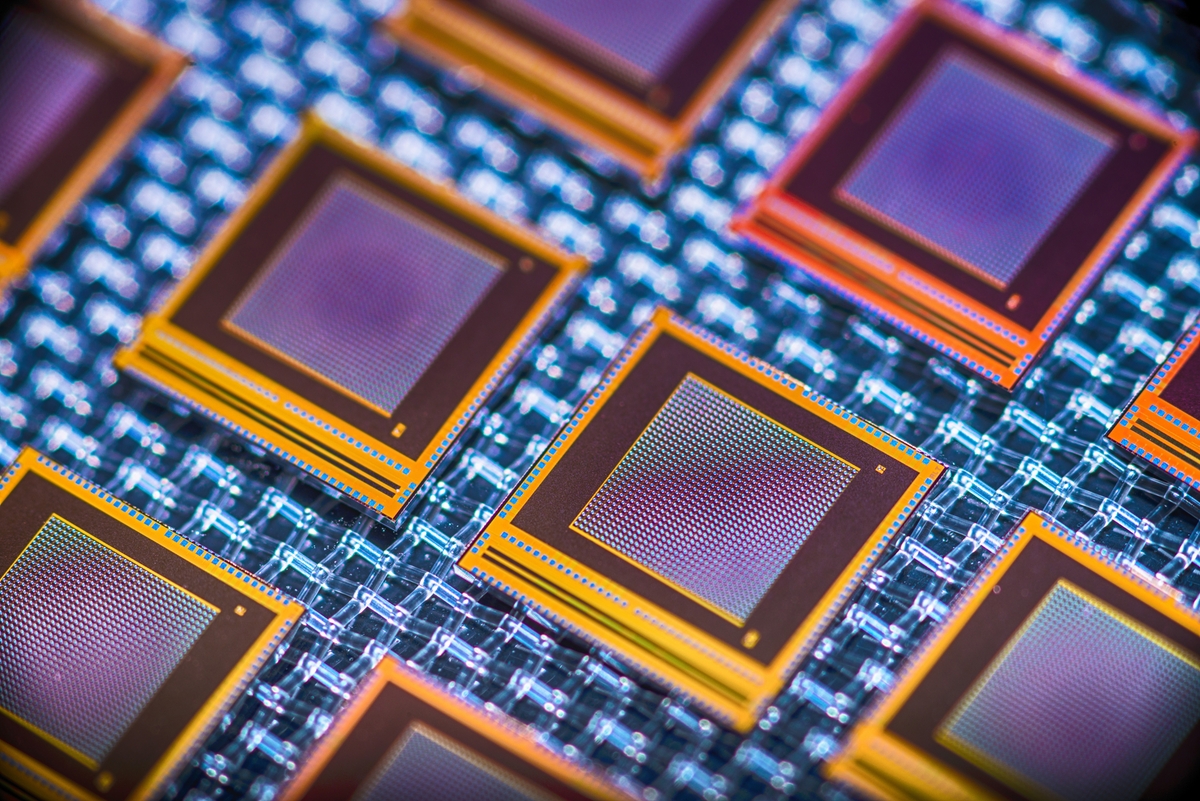 Stylized photograph of chip processors in blue, purple, and orange