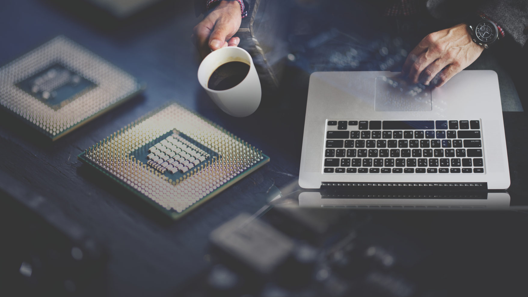 Stylized photograph of a person working on a laptop with coffee in one hand and overlaid with a computer chip processor