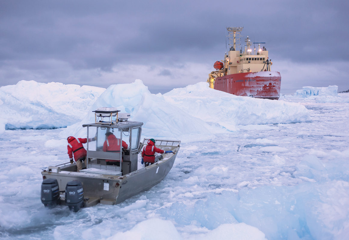 ArcticDEM Researchers with XSEDE traversing an icy seascape on a cloudy day