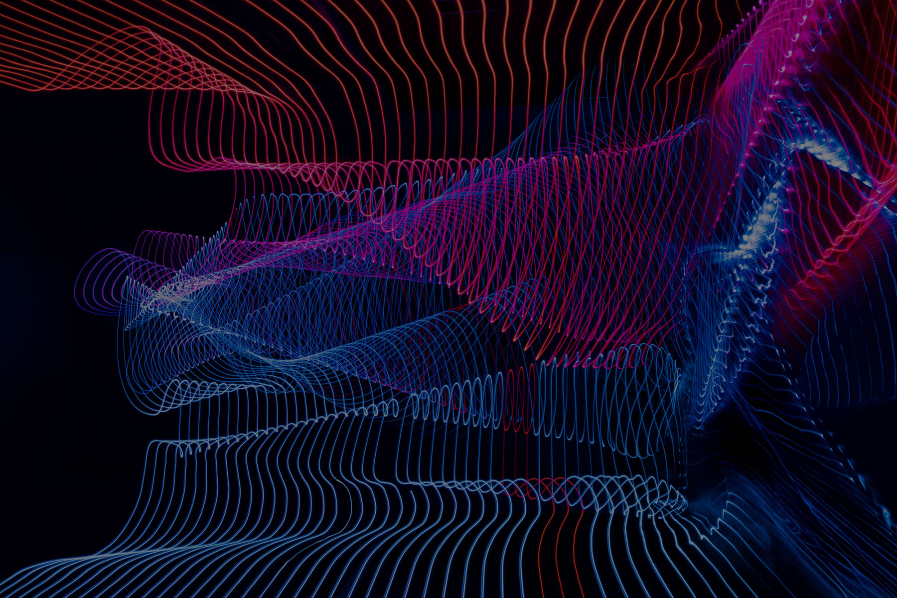 Abstract lines in wave formation that depicts motion from the top to bottom in red and blue