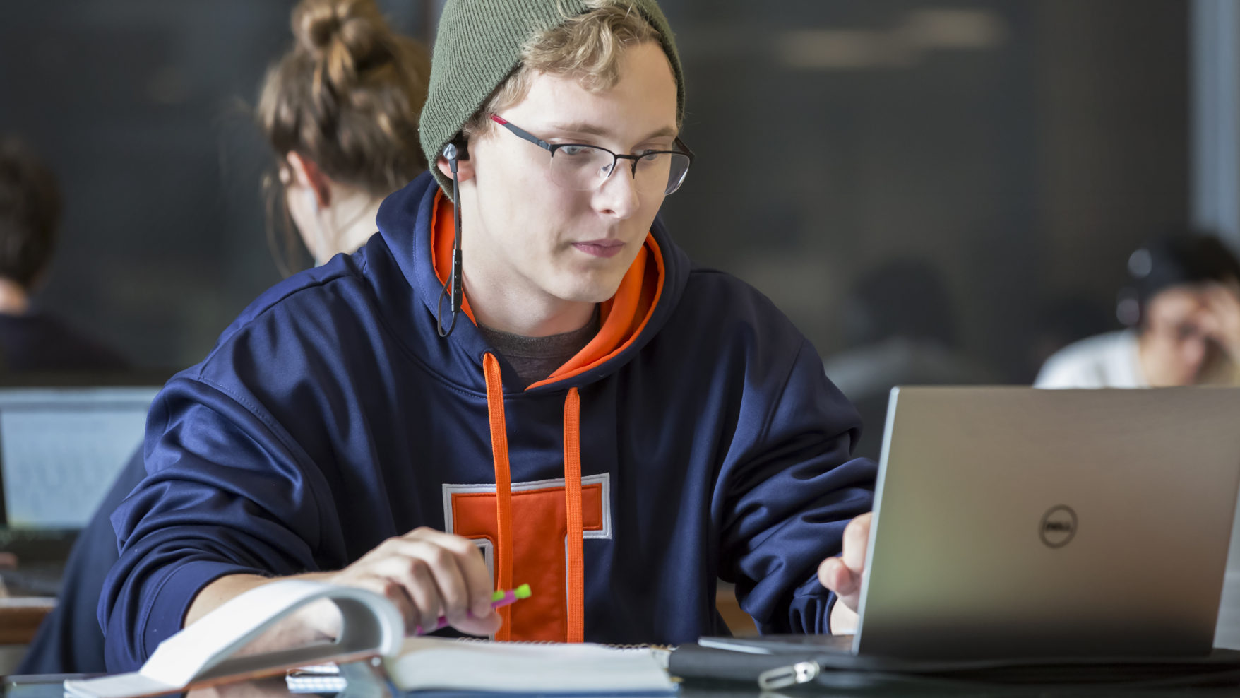Photograph of a male student studying in front of a laptop in the Electrical and Computer Engineering building