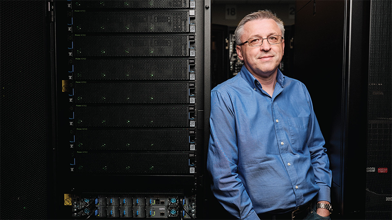 Volodymyr Kindratenko standing next to an HPC system.