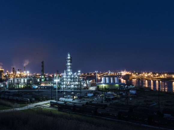 Exterior photograph of a Phillips 66 oil refinery at night with glowing lights