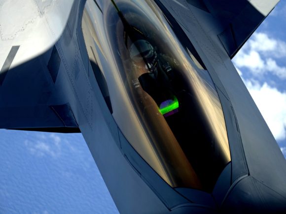 Photograph of a U.S. Air Force F-22 Raptor aircraft with the 1st Fighter Wing receiving a midair refueling from a KC-135 Stratotanker aircraft
