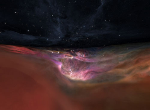 Screenshot from Behind the Scenes of Hubble 3D with orange, pink, and yellow gas clouds with white stars in a black sky