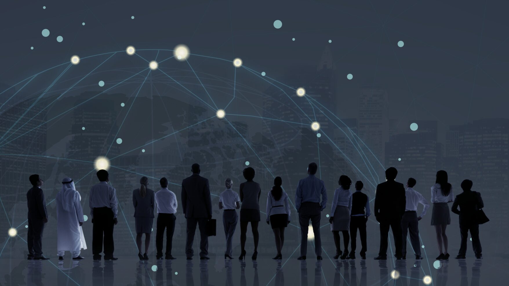 Silhouetted business people standing with global networks background