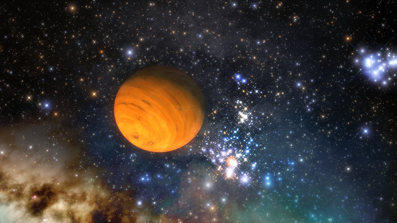 A bright orange free-floating planet in space surrounded by bright stars and red and blue cosmic gases.