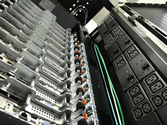 HOLL-I supercomputer interior image showcasing more than 11 rows of hard drives and cables