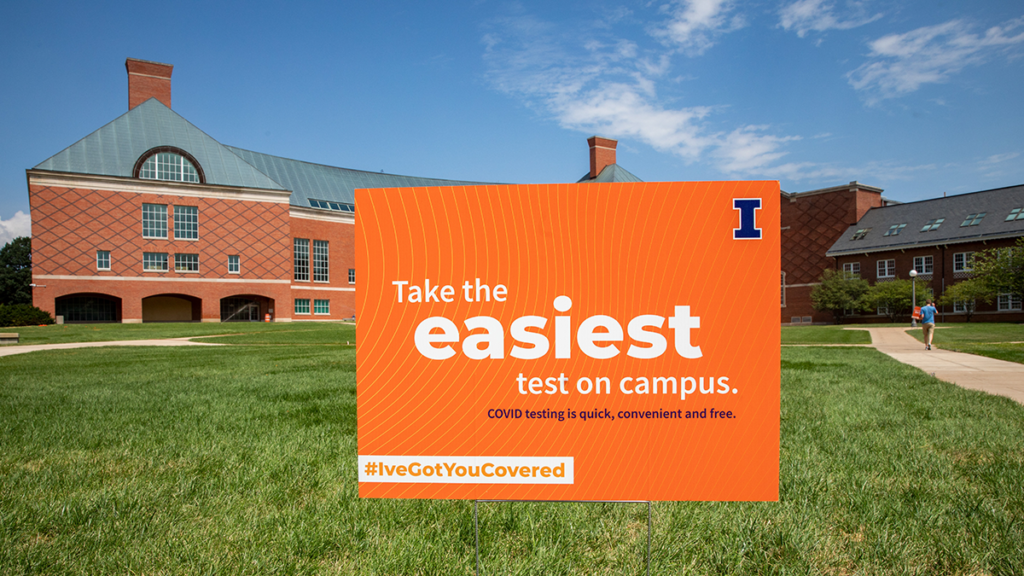 An orange lawn sign with text that states "Take the easiest test on campus. COVID testing is quick, convenient and free. #I'veGotYouCovered."