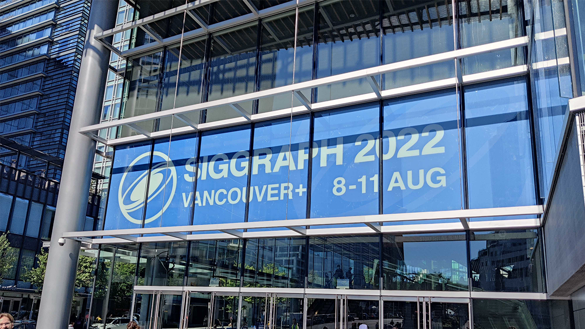 The SIGGRAPH 2022 sign displayed in the facade of the conference building in light blue and white text.