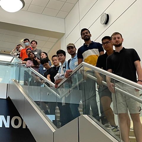 A photo of Datathon event participants on a staircase.