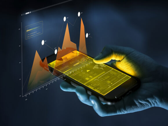 Smartphone analysis concept image - a person holding a smartphone with graphs overlaid