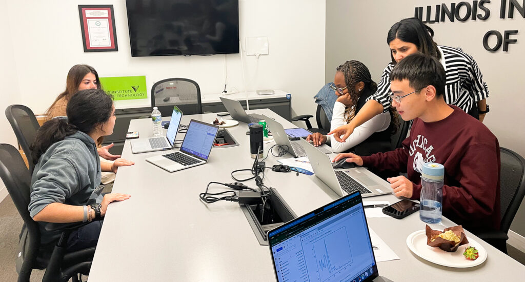 The Deep Dish Qubits team working on their solution with mentor Pooja Rao from Nvidia assisting.