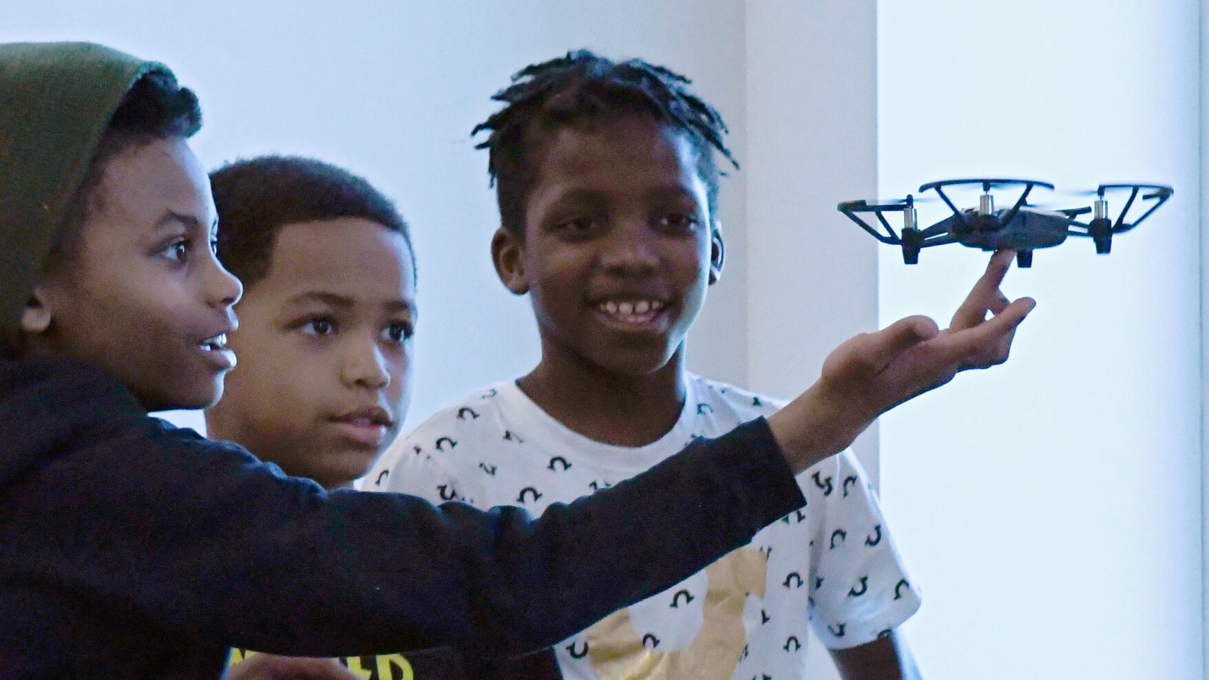 Photo of kids with a small drone