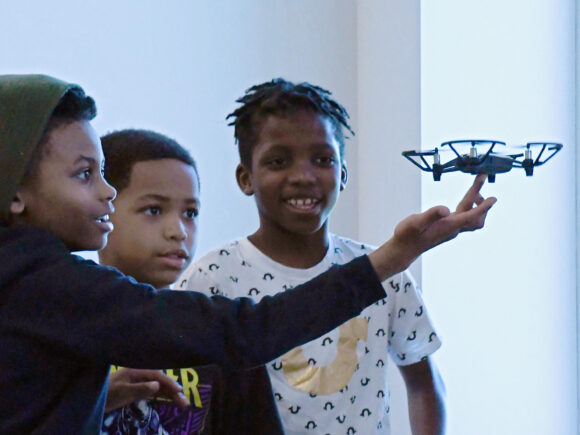 Photo of kids with a small drone
