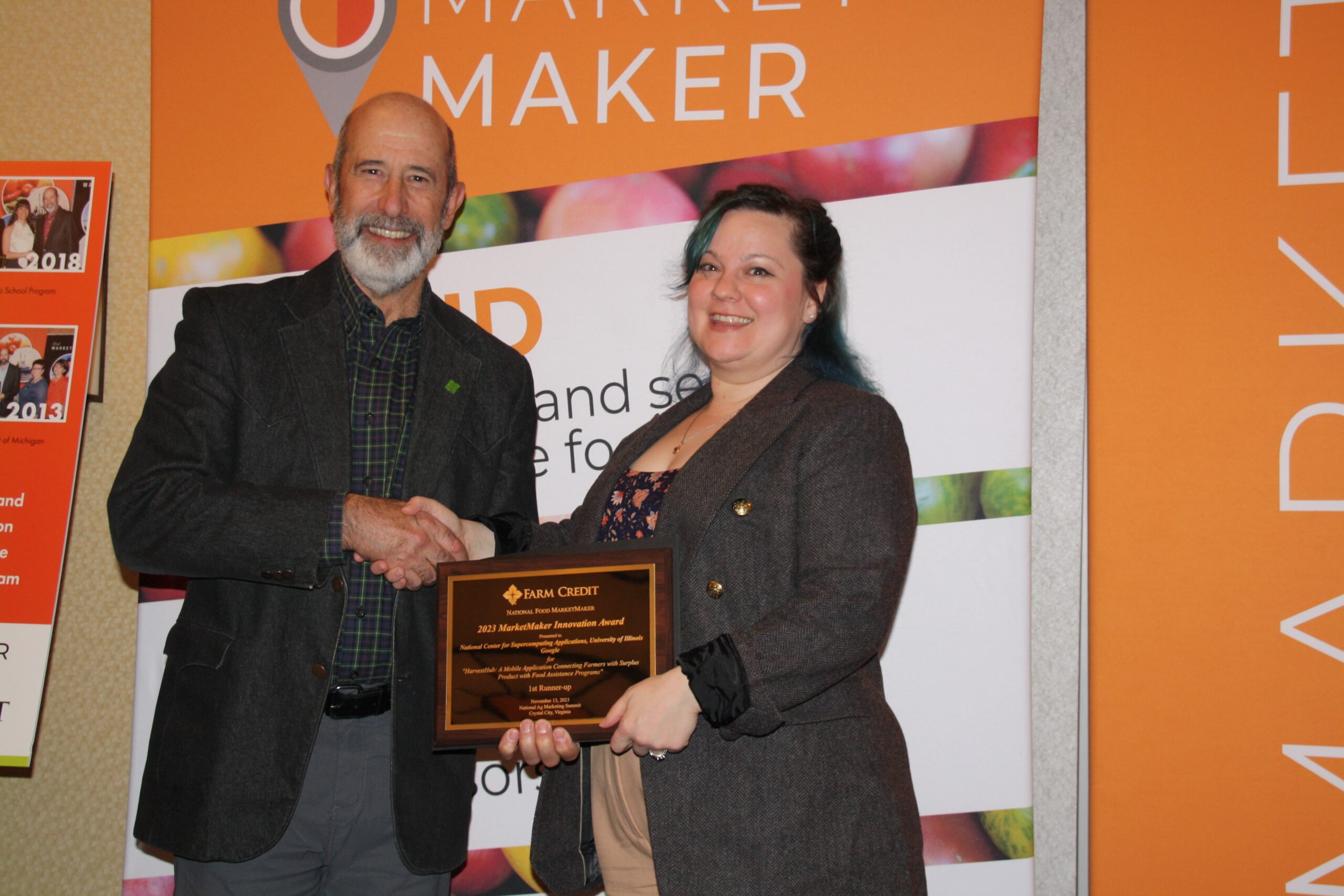 NCSA Genomics Lead Christina Fliege, right, accepts an award for HarvestHub at the 2023 National Agricultural Marketing Summit.