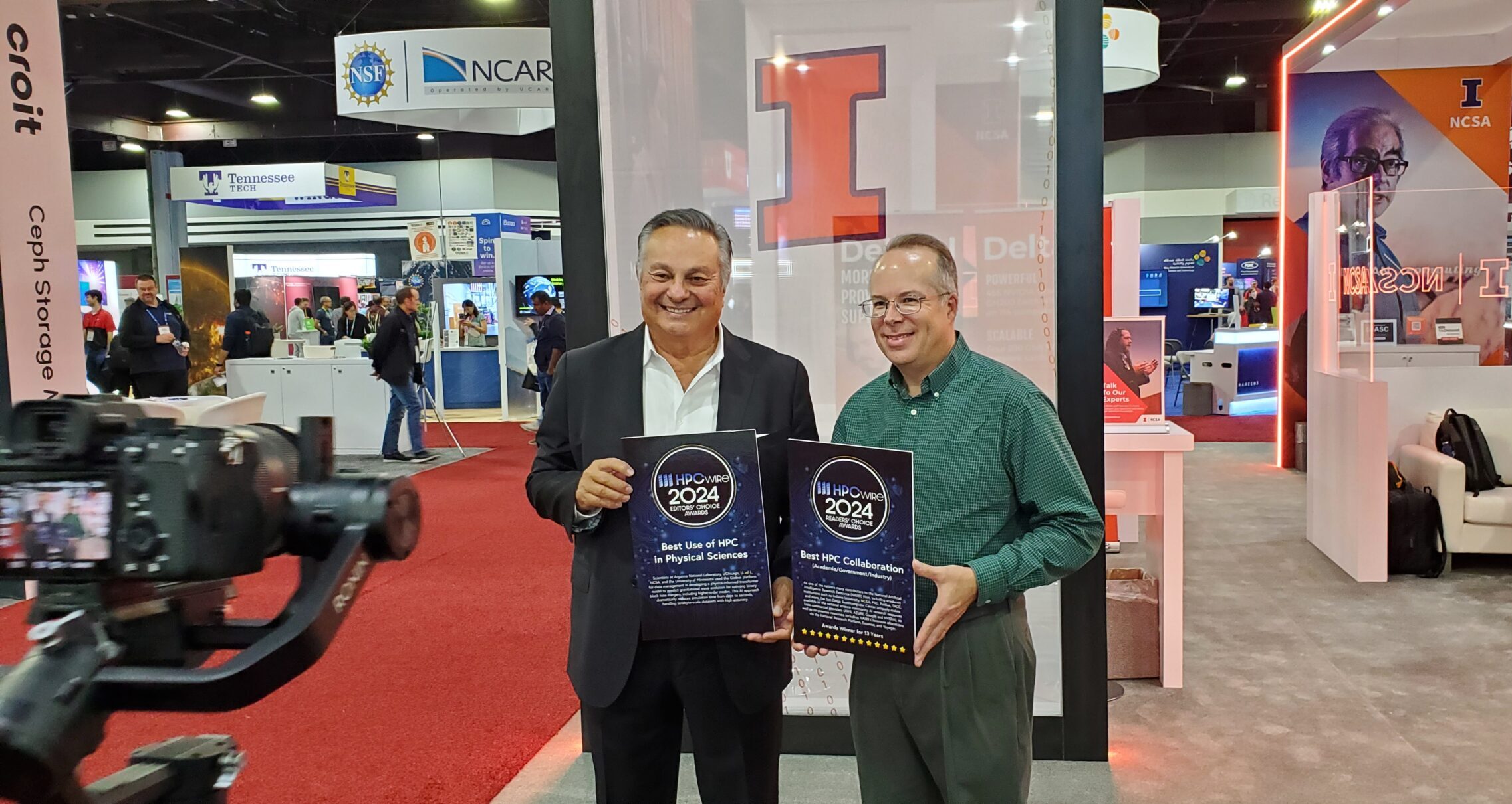 NCSA's Brett Bode (right) receives two 2024 HPCwire Readers' and Editors' Choice awards from Tom Tabor, CEO of Tabor Communications, the publishers of HPCwire.