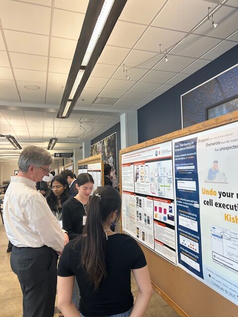A picture of NCSA director Bill Gropp viewing a poster presentation at NCSA.