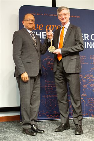 Dean of The Grainger College of Engineering Rashid Bashir presents NCSA Director Bill Gropp with his medal during his investiture as Grainger Distinguished Chair in Engineering.