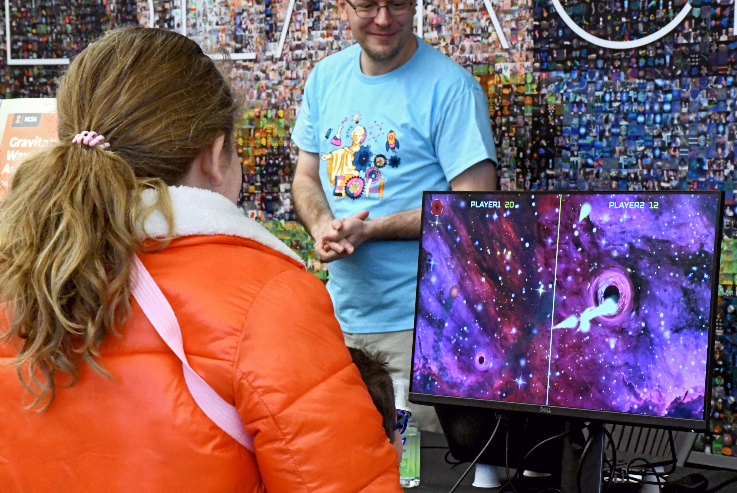 A young girl playing black hole pong at EOH.