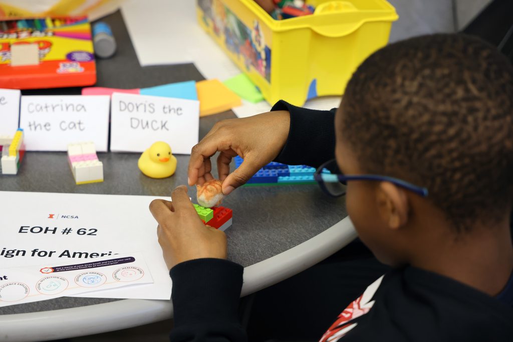 A student makes a craft.