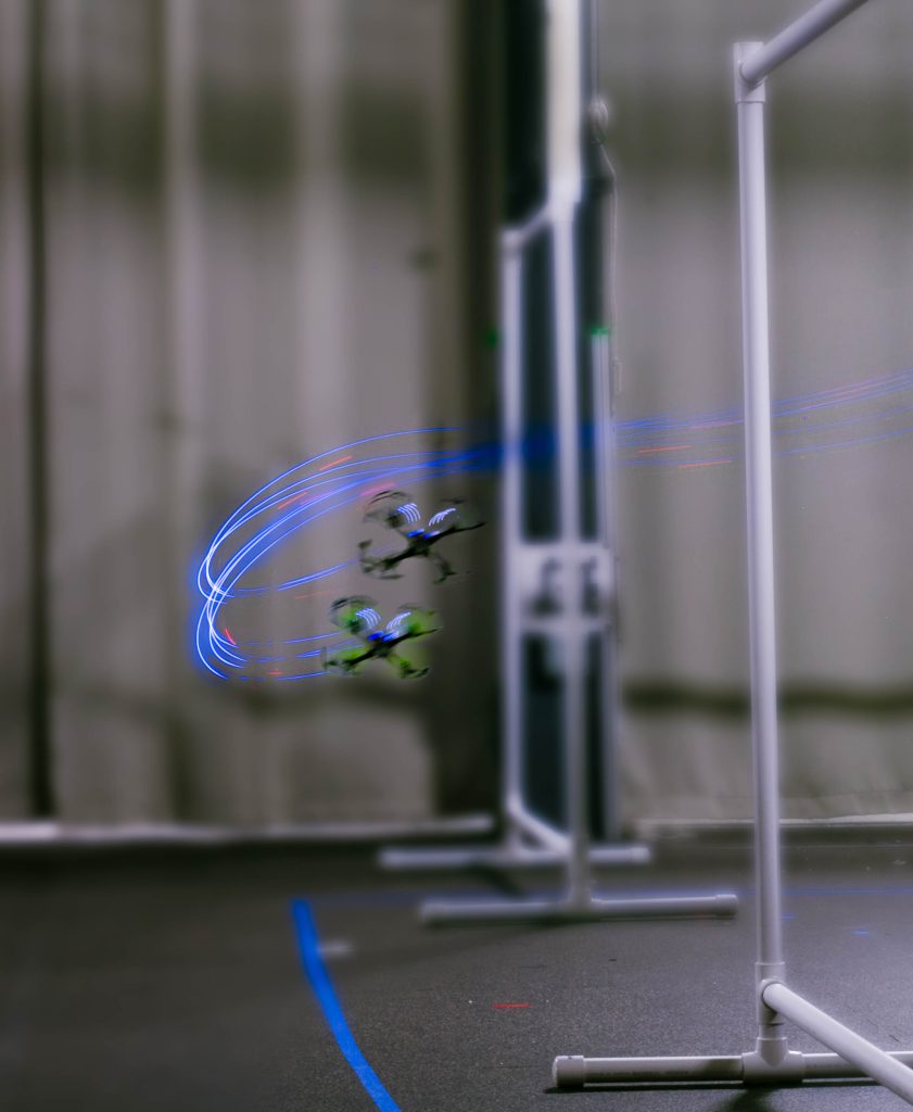 The drones flying around obstacles.