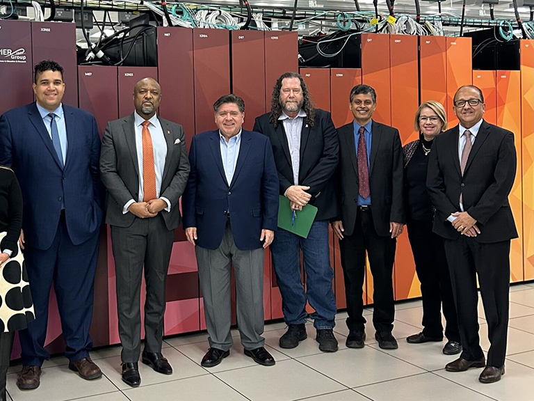 R. Srikant stands with Governor Pritzker and others in front of the Delta supercomputer.