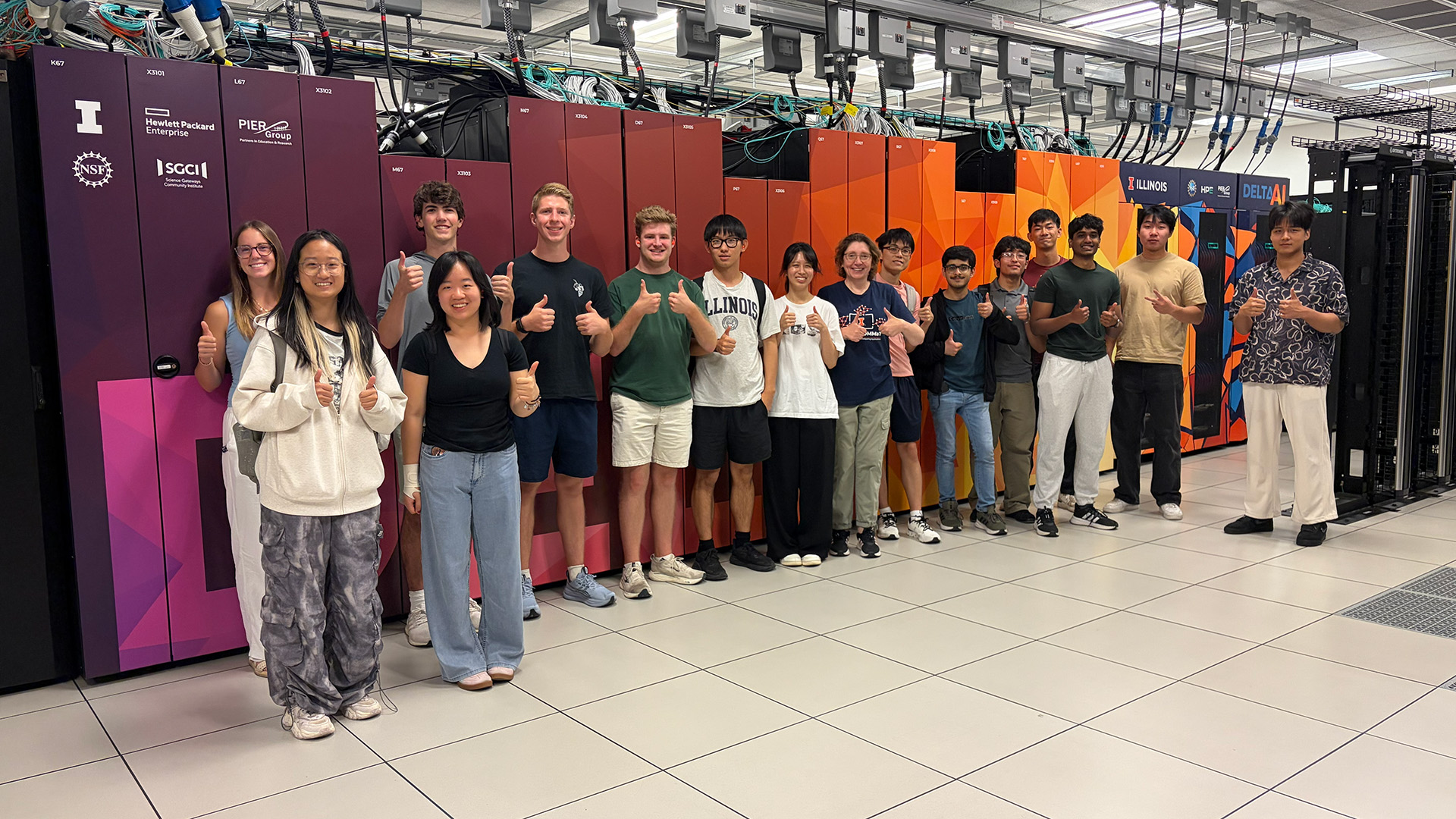 SPIN students stand in front of the Delta supercomputer.