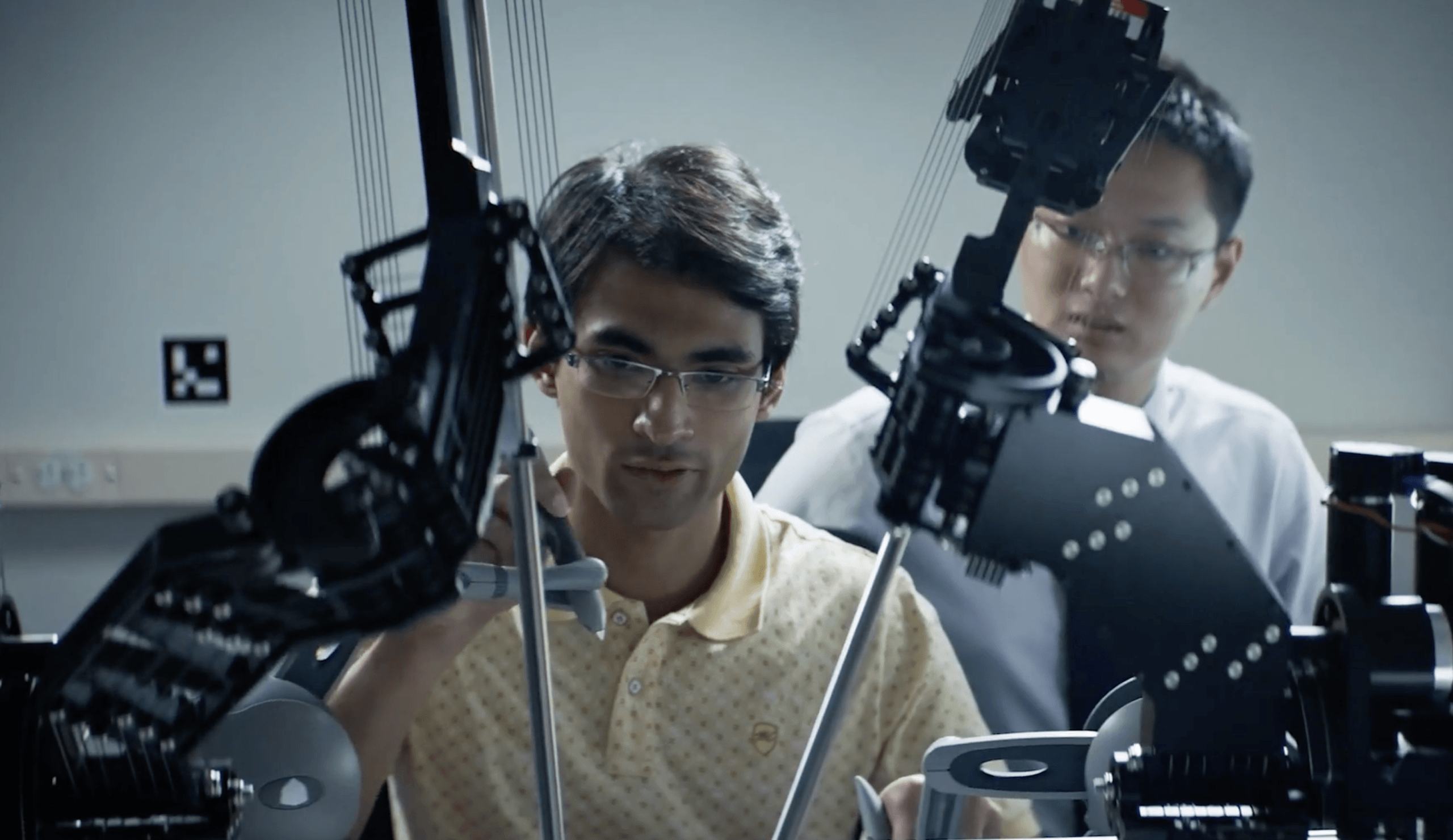 Two experts hone their skills on a cutting-edge surgical robot